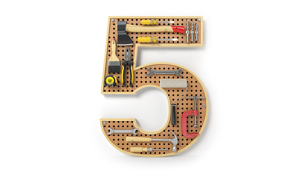 A pegboard in the shape of a number 5 with tools on it