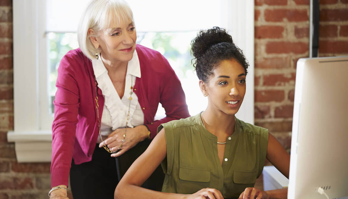 two women working at a computer station