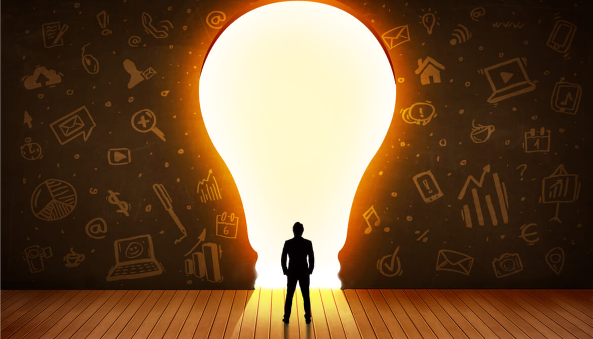 man stands in front of bright light bulb door