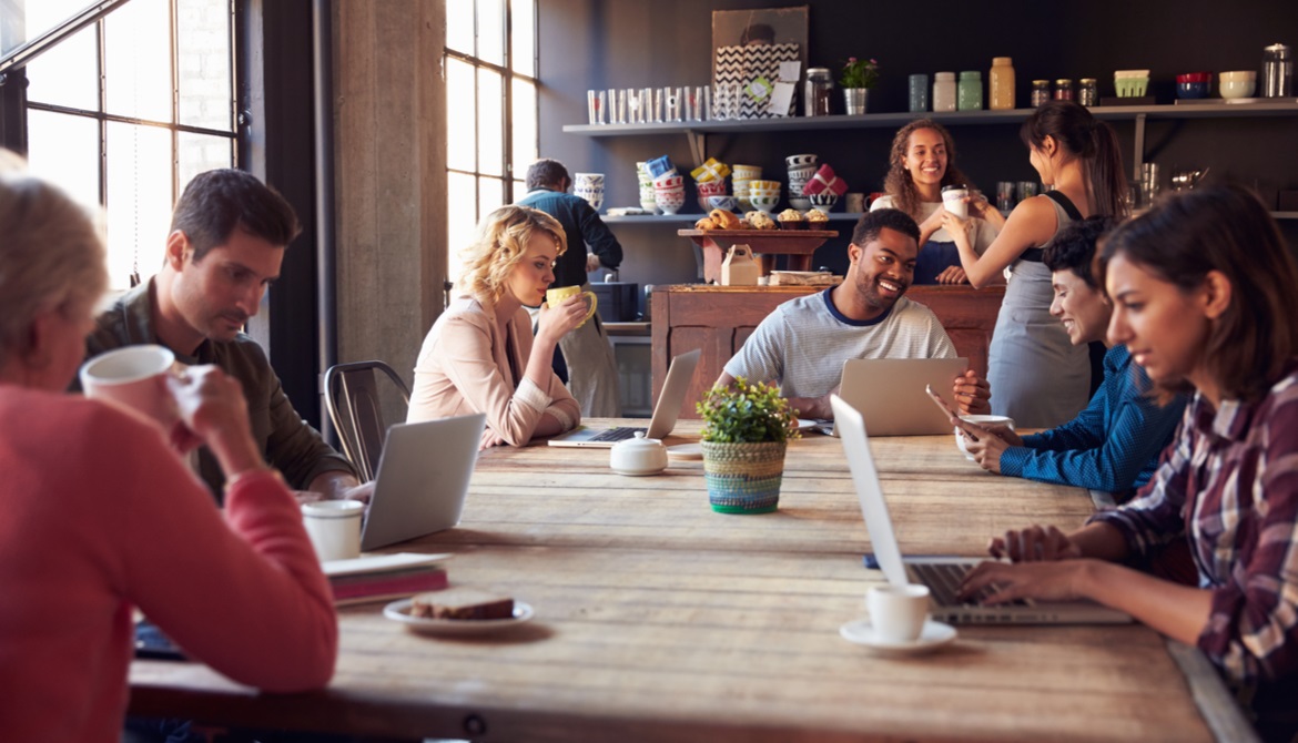 many customers working on laptops at a coffee shop