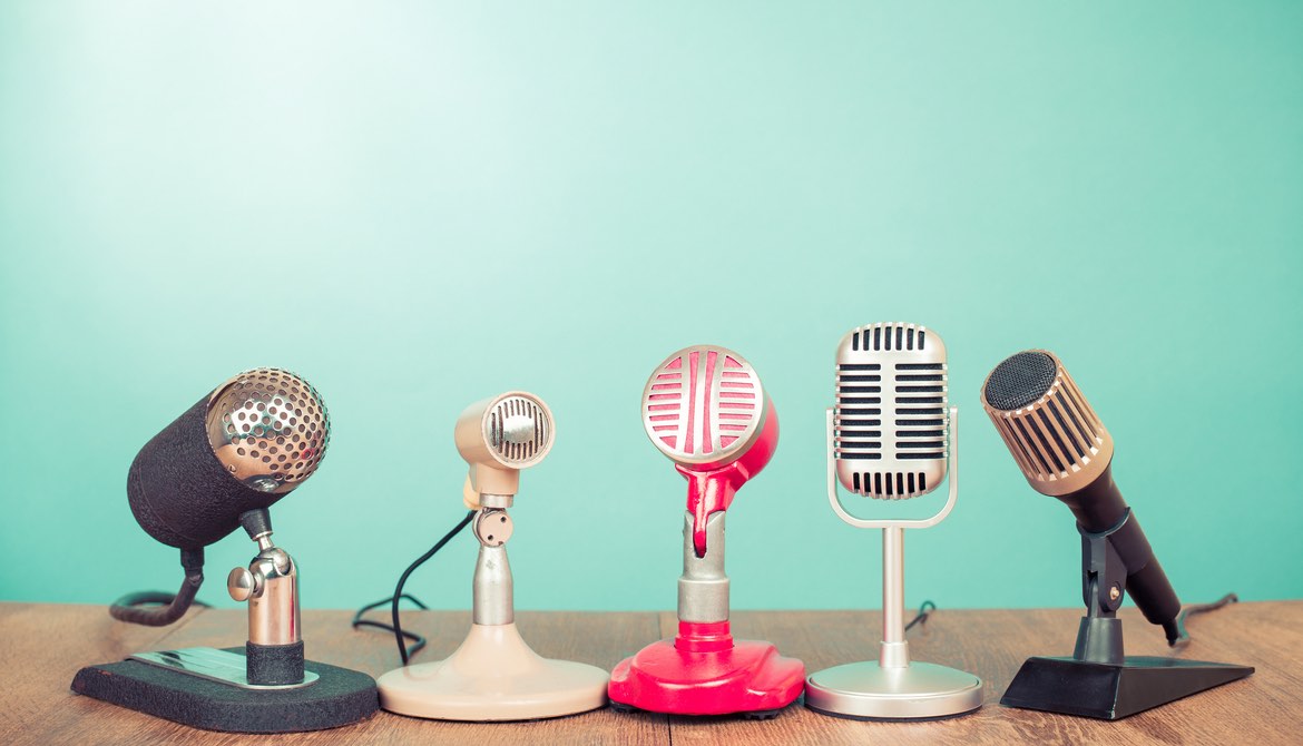 old style microphones on a mint green background