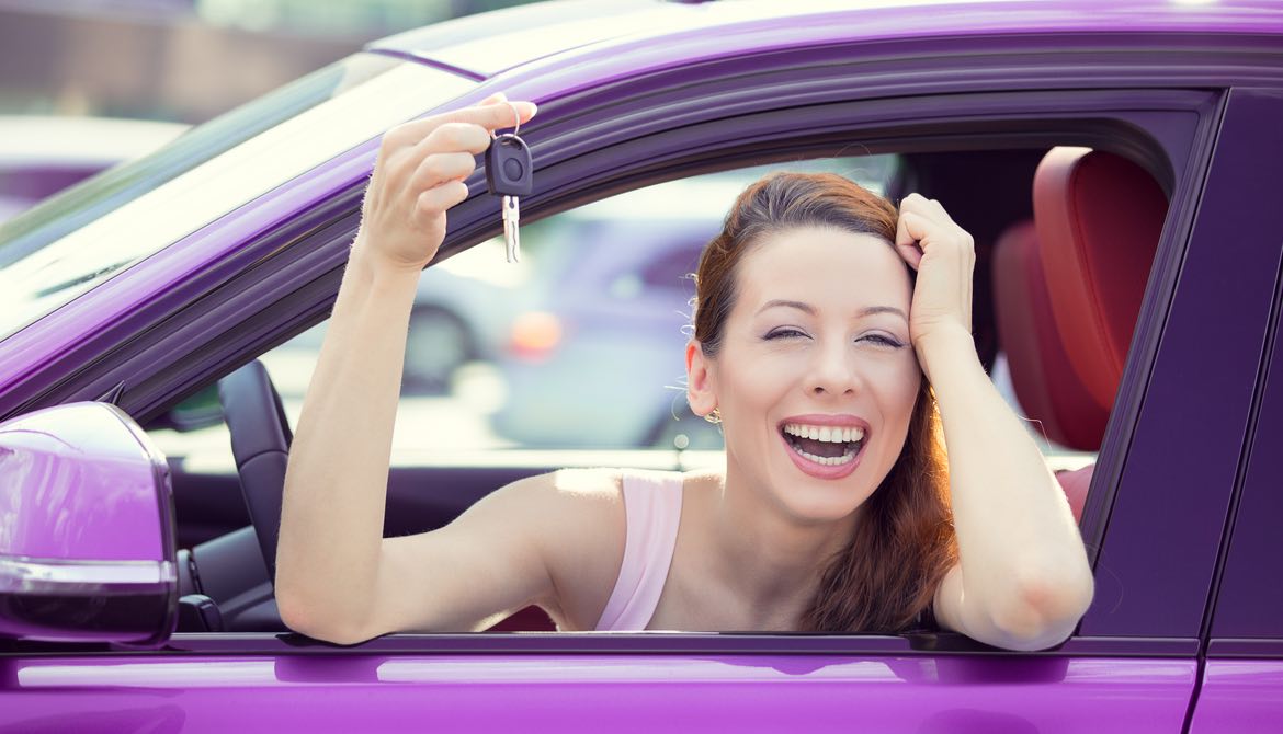 happy woman in purple car with keys