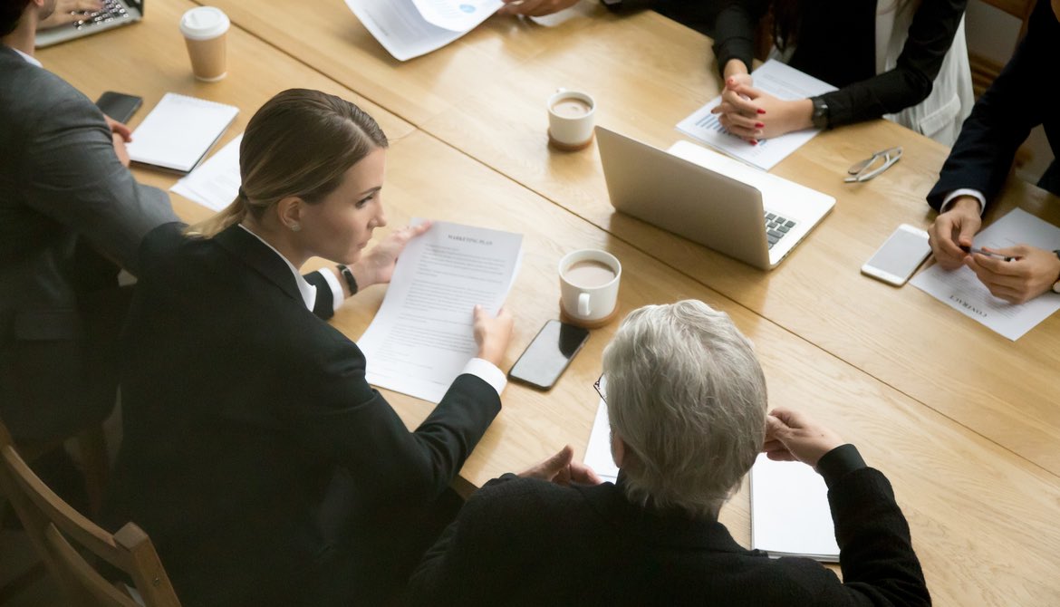 two women at a negotiation table