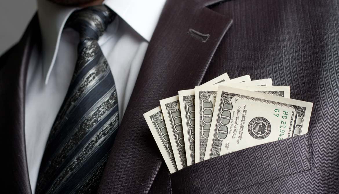 male executive with cash in his suit coat pocket