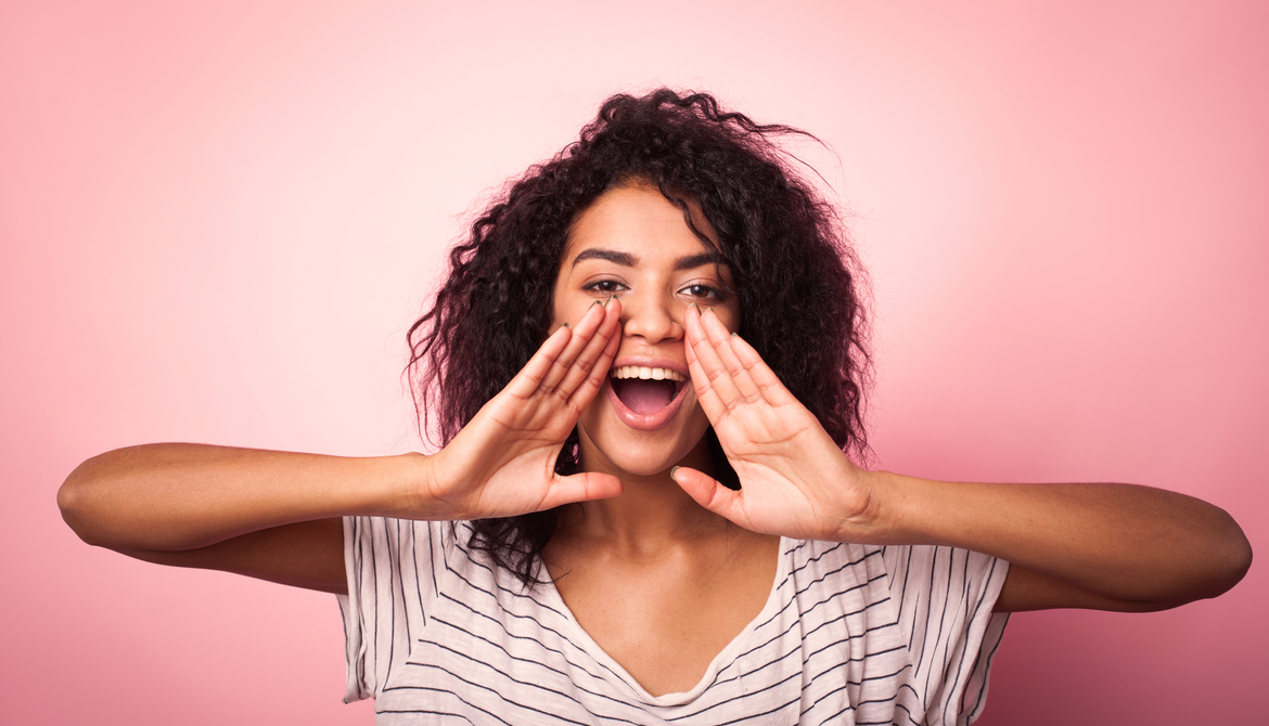 young woman cupping her mouth to be better heard