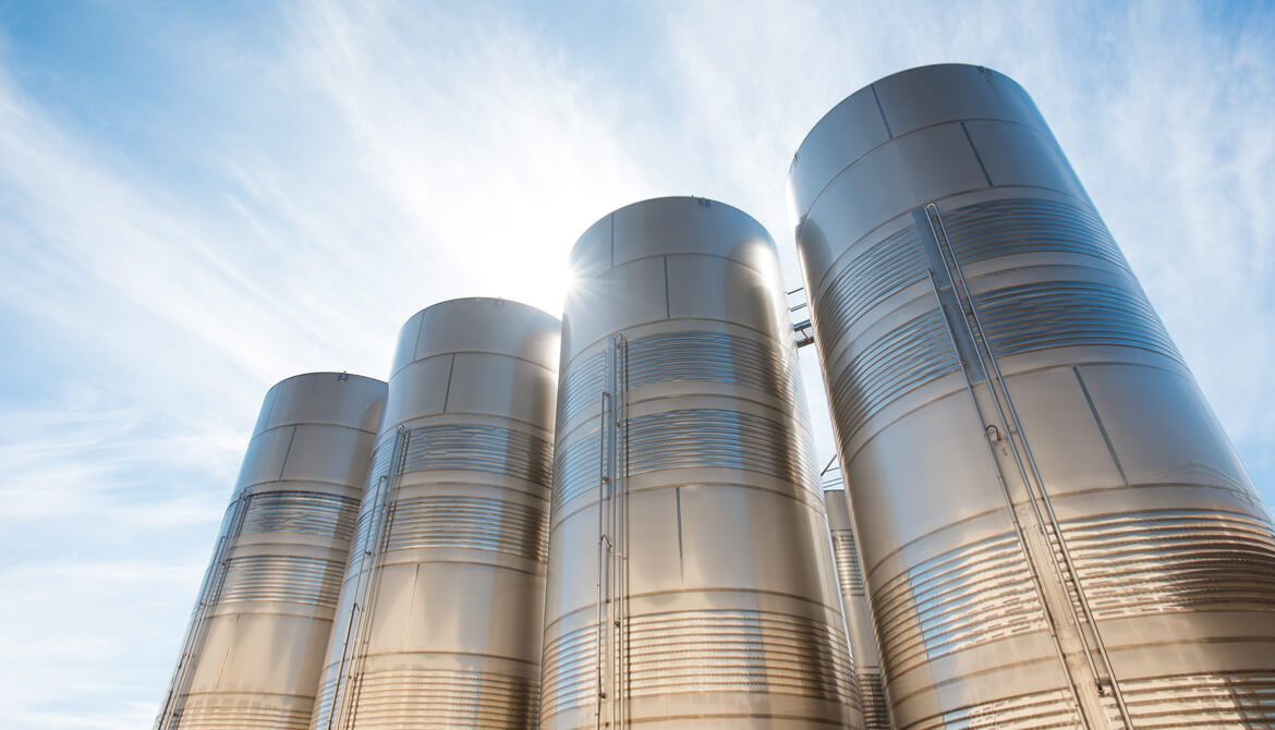 Looking up at a group of industrial siloes