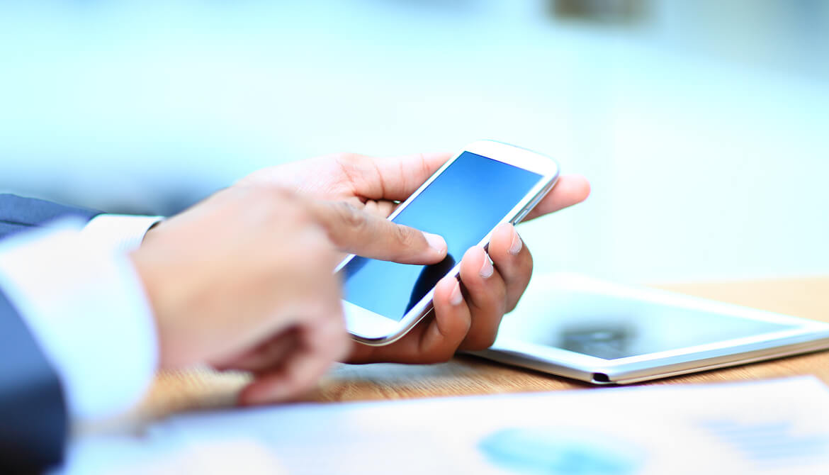 Young businessman working on mobile smartphone