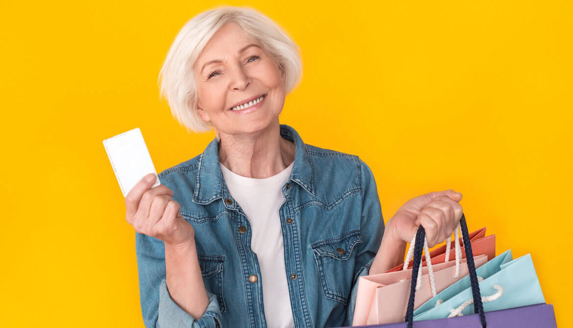 happy senior woman shopping with credit card