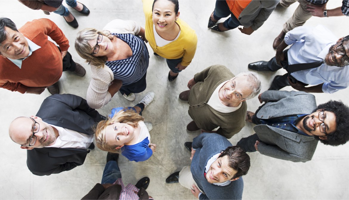 diverse group of happy people looking up at camera