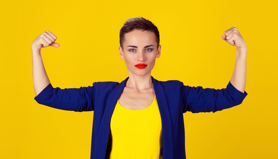 young businesswoman flexing her arms confidently