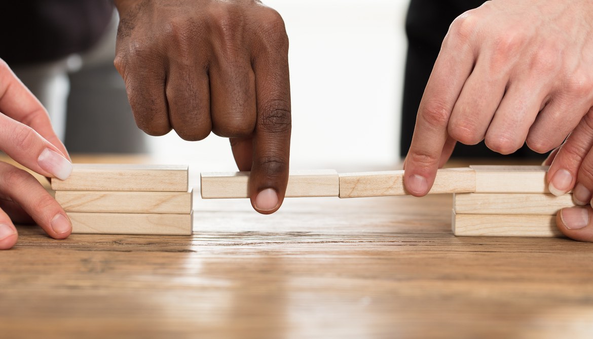 diverse hands close gap in towers of blocks