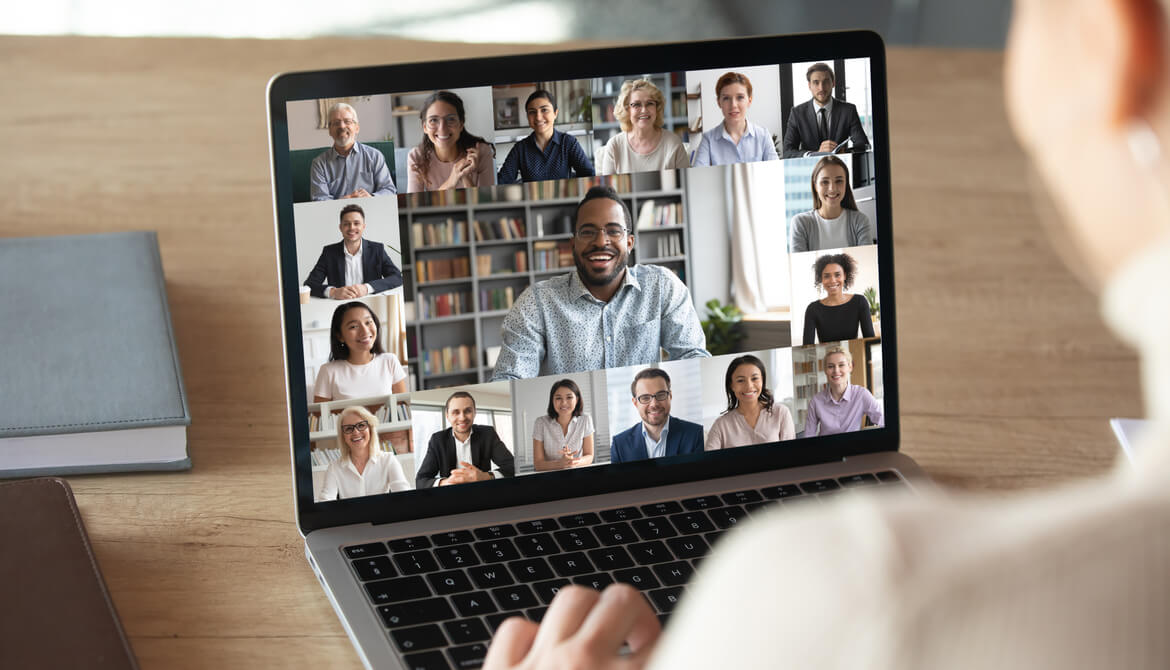 female attends virtual meeting using laptop