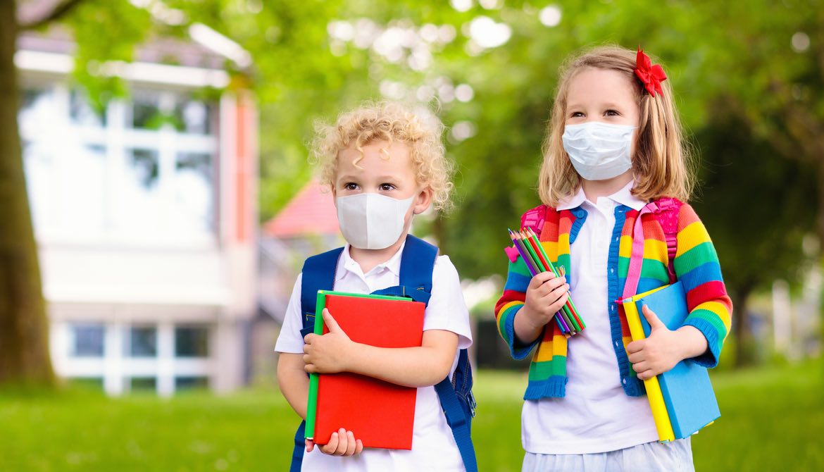 two school girls in masks