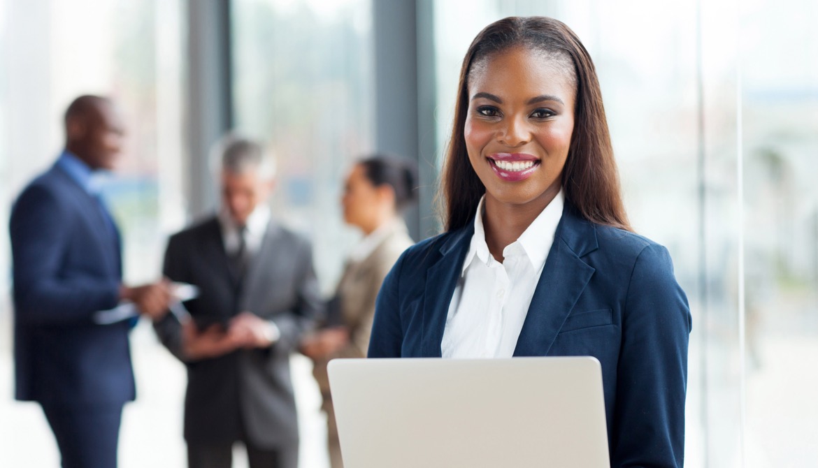 female director with laptop in front of a group