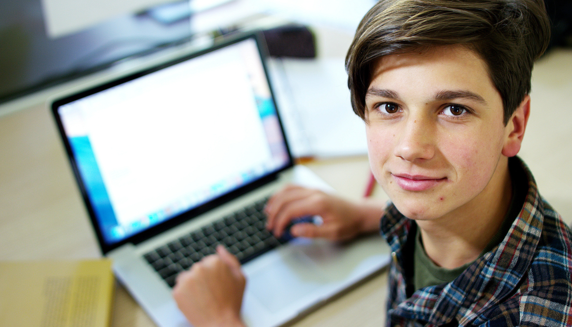 student with a laptop in the classroom