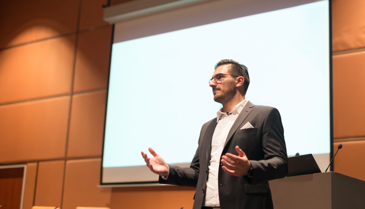 presenter in front of screen in conference room