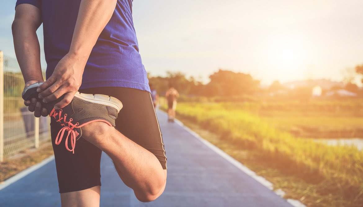 a runner stretching to warm up