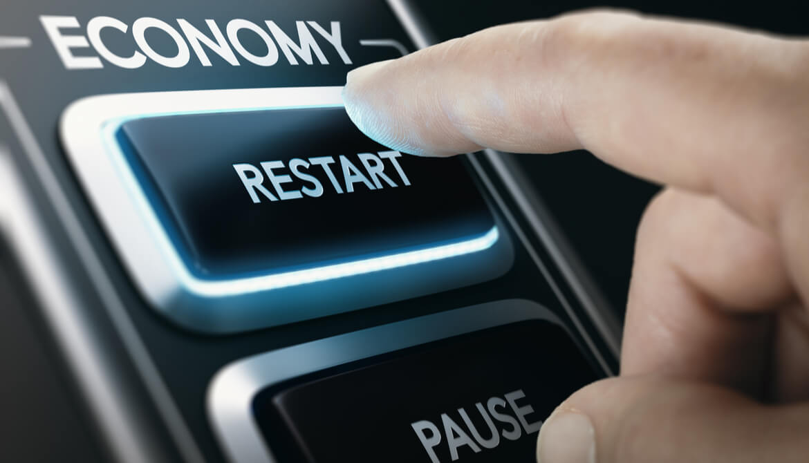 man pressing economic restart button