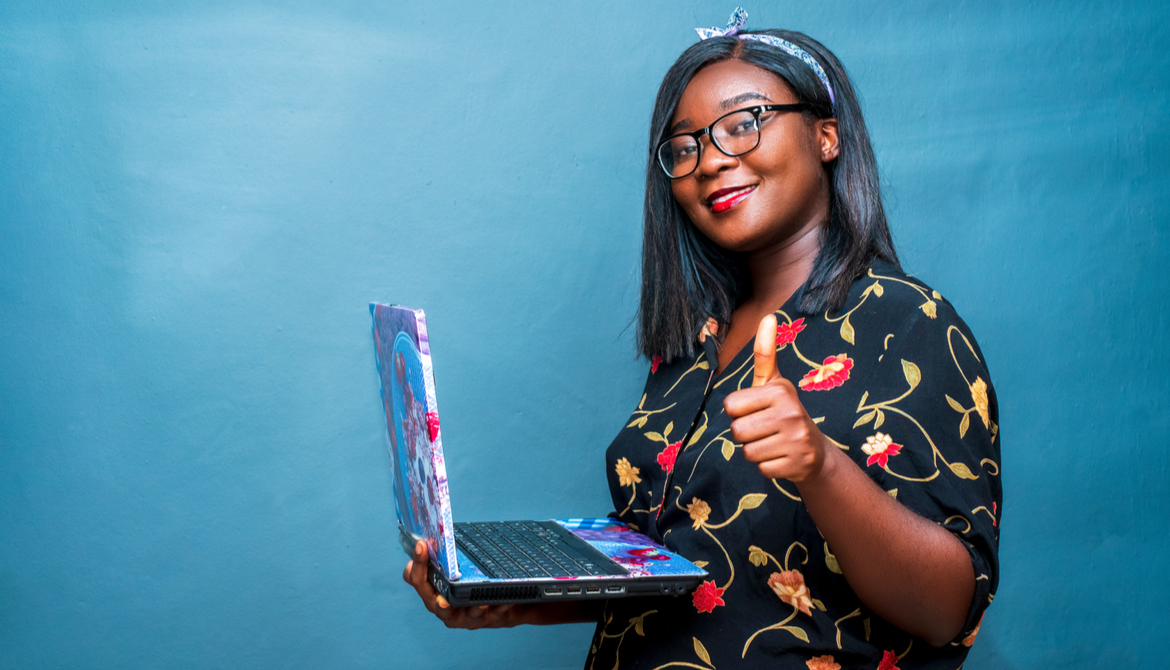 Black woman with her laptop giving a thumbs up