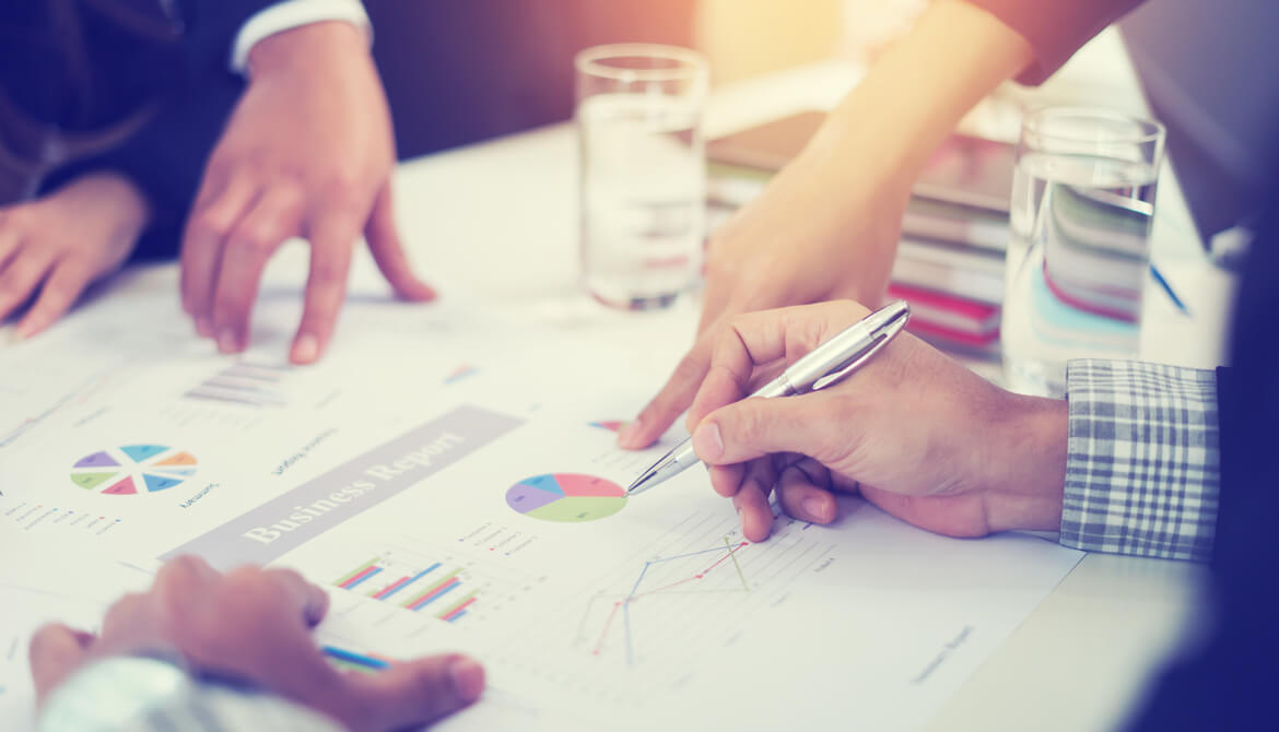 executives work on financials at table