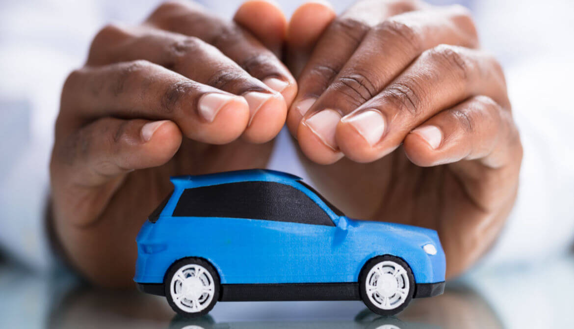 hands protecting blue car