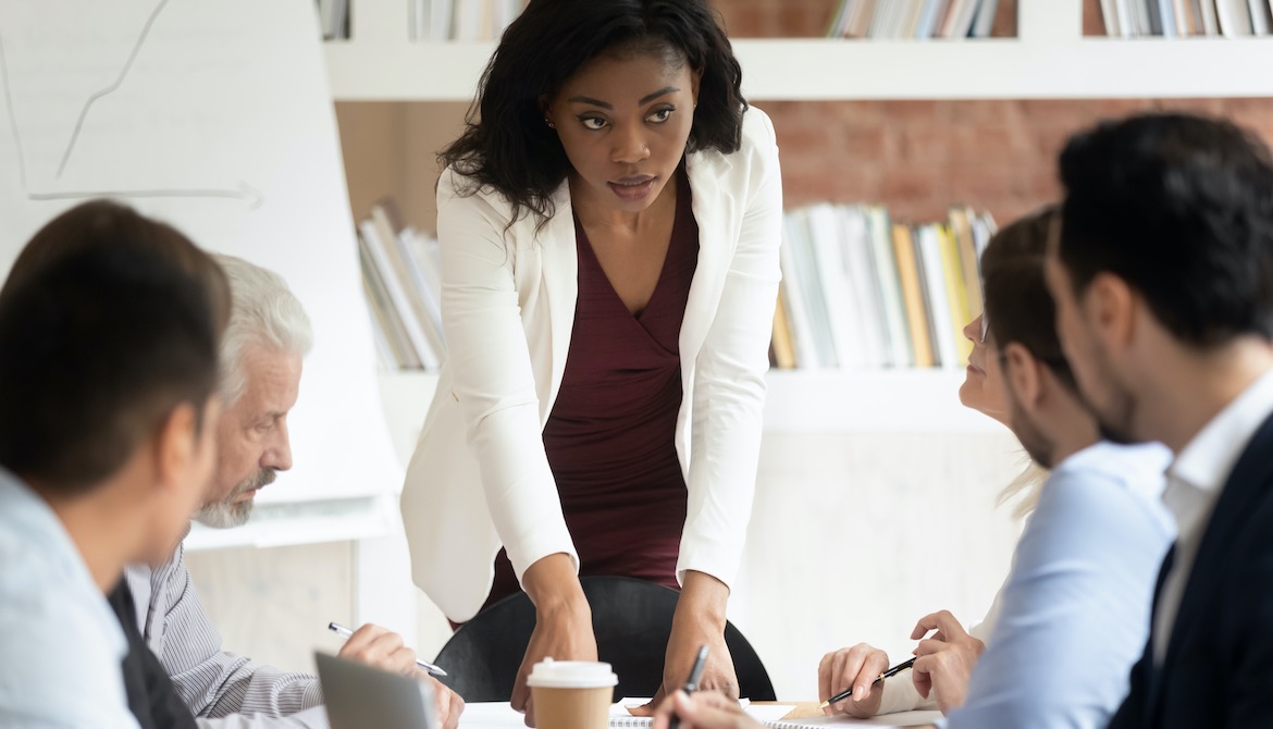 young Black woman leads board meeting