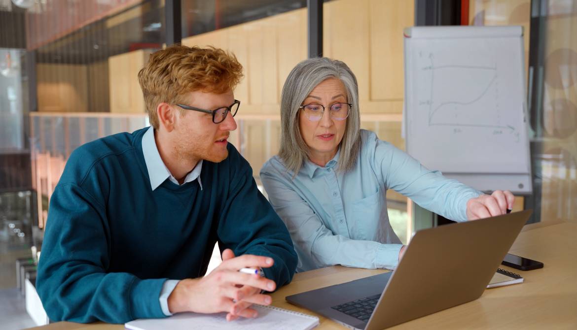 gray-haired executive mentoring young professional