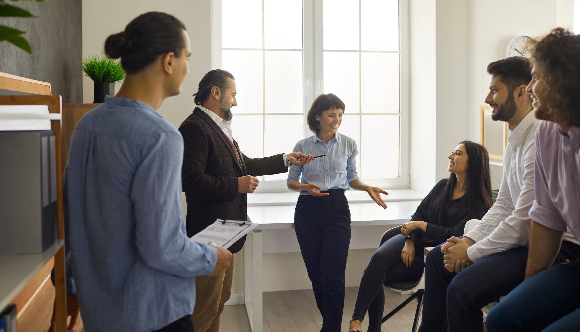 Group of coworkers listening as one tells a story