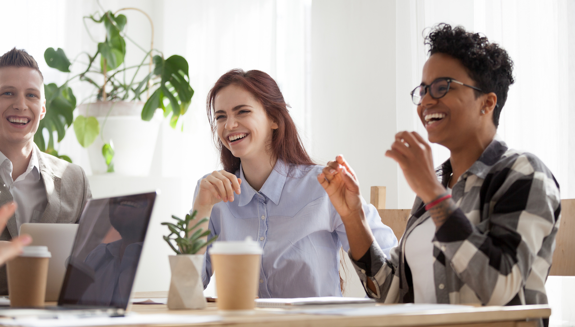 young-employees-laughing-coffee-table