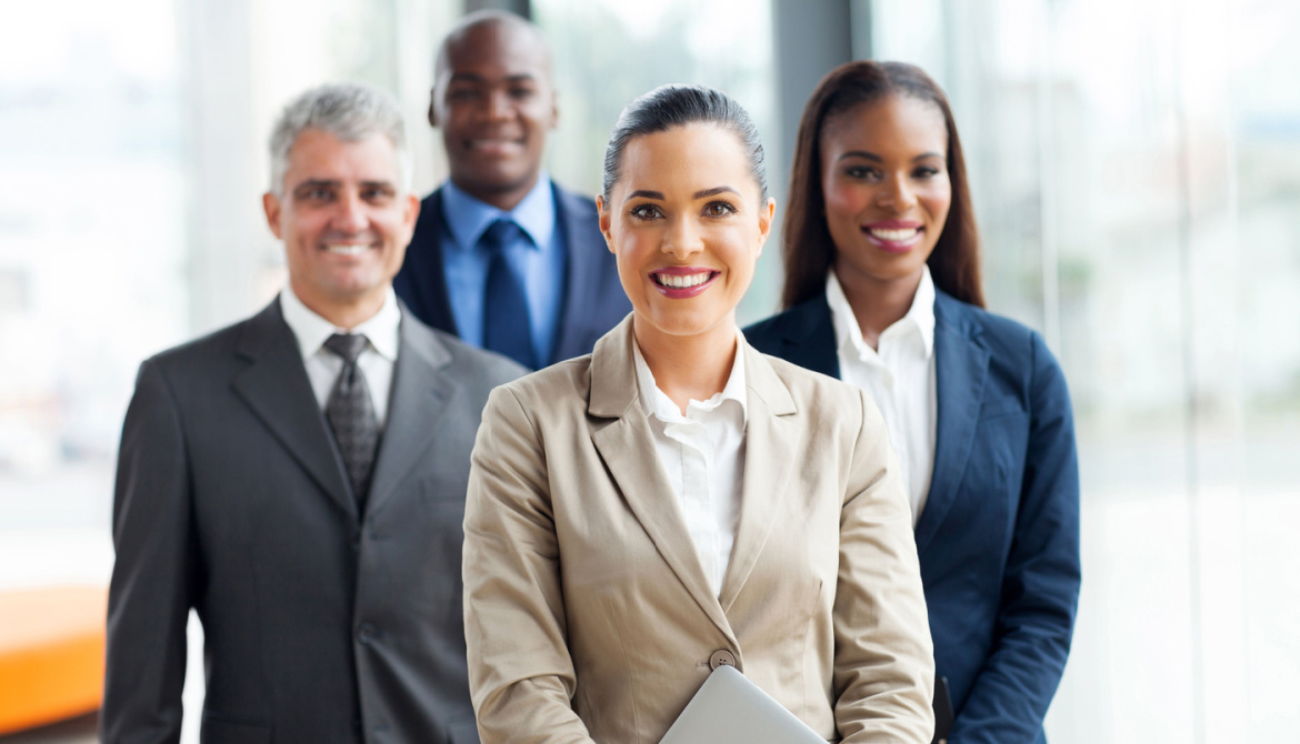 a group of four executives stand together