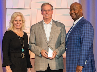 In photo at right, starting from the left: CUES Chair Kim Sponem, CEO/president of Summit Credit Union, Madison, Wisconsin, Joe Newberry and CUES President/CEO John Pembroke