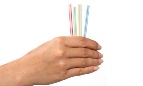 hand holds a collection of colorful straws