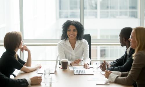 young African American female executive meeting with her team 