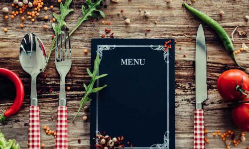 menu as part of a placesetting on a table