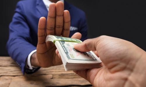 businessman refusing to take money being offered