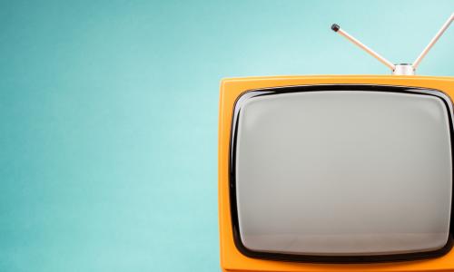 yellow television with antenna