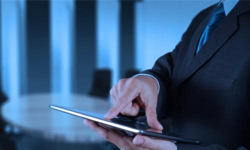 businessman working with tablet computer his board room in the background