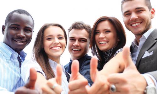 Group of employees giving the thumbs up to camera