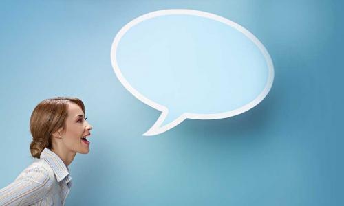 Woman speaking assertively with a blue speech bubble