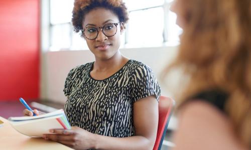 African American woman manager conducting interview with female employee