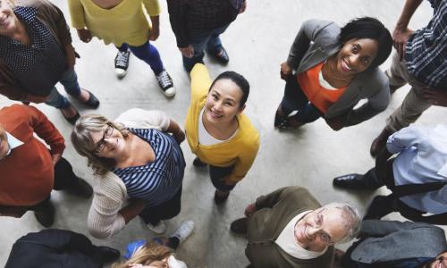 group of diverse people looking up and smiling