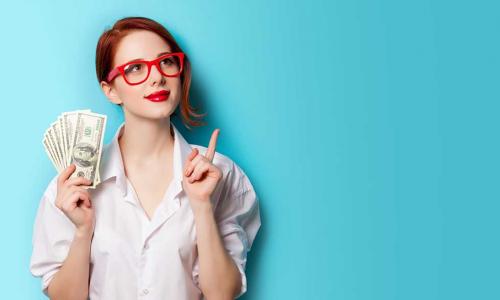 thoughtful young woman wearing glasses and holding several 100 dollar bills