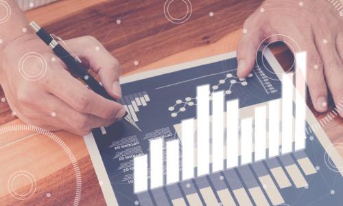 hands interacting with tablet projecting holographic report of finances