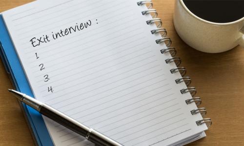 Exit interview checklist written on notebook