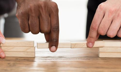 diverse hands close gap in towers of blocks