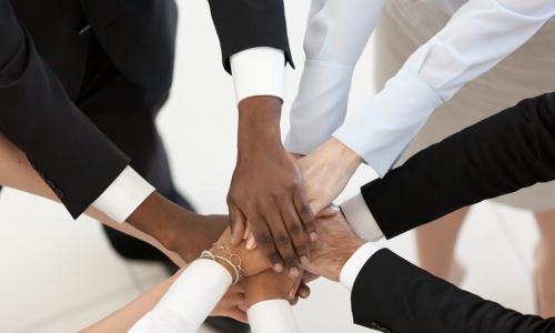 diverse business people put hands together