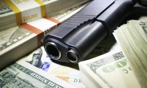 gun on top of money