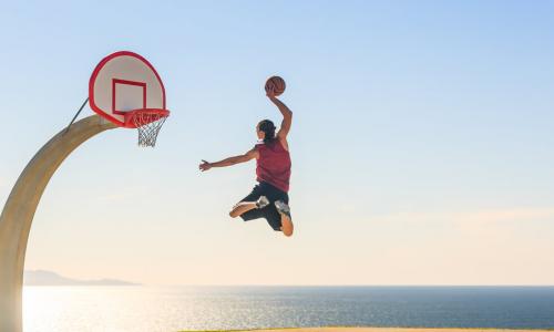 basketball player scoring amazing slam dunk