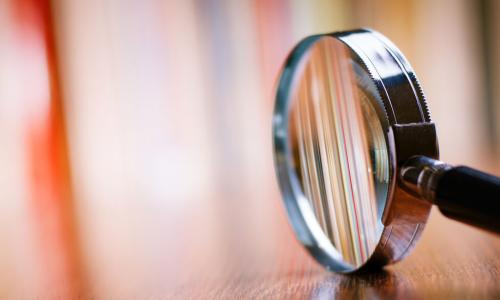 magnifying glass on table with blurred background