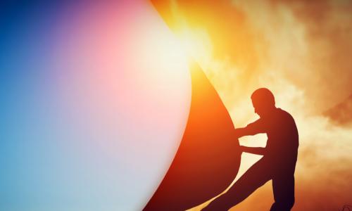 man pulling back curtain to reveal blue sky